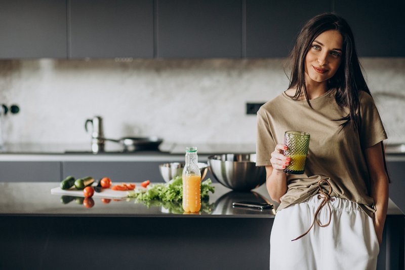 young-woman-drinking-juice-home